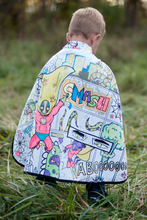 Load image into Gallery viewer, Every hero needs a cape! The Colour-A-Cape Spider Superhero is the perfect addition to your crime-fighter's wardrobe. Save the day or defeat monsters in the backyard with personalized style and flair! Includes 6 markers. This cape is also reversible with a red spider printed satin on the other side.