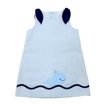 Load image into Gallery viewer, This enchanting Girl's Eloise Seersucker Whale Dress combines timeless blue and white seersucker fabric with a charming whale applique that's sure to make a splash. Perfect for summer gatherings, beach outings, or special occasions, this playful yet elegant dress from Zuccini Kids will keep your little one cool, comfortable, and utterly adorable all season long.