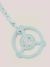 Load image into Gallery viewer, Help soothe your baby’s sore gums with the Silicone Teether Ring with Detachable Clip from JuJuBe x Studio Oh! This teether features an easy-to-grip design and three different massaging textures so Baby can choose what feels best. Place it in the freezer before use for additional cooling relief. This nontoxic, food-grade silicone teether is dishwasher-safe, and most importantly, it is BPA-free, PVC-free, phthalate-free, and lead-free, making it safe to go in Baby’s mouth. A snug-closing clip and silicone lo