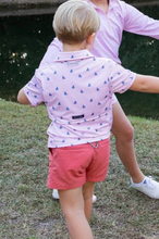 Load image into Gallery viewer, No matter the adventure, your boys will be ready in these fast-drying, UV-protective, boys' short-sleeve pro performance polo shirts in Pink Fishing Print. Our boys' polos keep moisture out with wicking technology, breathable fabric, and the signature vented back. PRODOH polo shirts are perfect for golf, tennis, country clubbing, or cruising the coast. 
UPF 50 95% Polyester 5% Lycra
100% Polyester Mesh Liner
Collar Interfacing for Structure
3 Button Placket/Extra Button Included
Vented Back