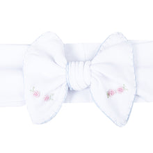 Load image into Gallery viewer, Add a touch of elegance to your little girl's outfit with Charlotte's Classics Embellished Headband. Featuring stunning blue embroidery and delicate rosettes, this headband from Magnolia Baby is perfect for infant girls. Elevate any look and make your little one feel like a princess. Pairs perfectly with other styles within the Charlotte's Classics Collection.
