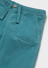 Load image into Gallery viewer, Soft corduroy infant pants in a rich teal tone, crafted with a cozy striped jersey lining for all-day comfort. The fabric make these an everyday essential that pairs beautifully with the Mayoral Bear Sweater for a coordinated look. Perfect for layering through seasons, these pants bring texture and warmth to your little one's wardrobe.