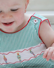 Load image into Gallery viewer, Dress your little one in festive charm with the Boys Jean Nutcracker Jon Jon from The Yellow Lamb. This adorable outfit features a classic green and white stripe pattern accented by detailed nutcracker embroidery on the front. Ideal for Santa visits or family photos, it combines comfort and holiday spirit effortlessly, making your baby the star of any seasonal occasion.