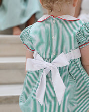 Load image into Gallery viewer, The Girls Nutcracker Kelly Bubble from The Yellow Lamb combines festive charm with elegant details, featuring green and white stripes complemented by an embroidered sash adorned with Nutcracker motifs. Accented with refined piping along the Peter Pan collar and sleeves, this bubble is a perfect choice for Christmas pictures and magical Santa visits, ensuring your little one looks both classic and captivating this holiday season.