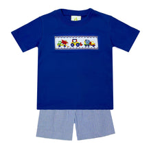Load image into Gallery viewer, The Construction Smocked Play Tee is perfect for little ones who love to play with construction vehicles. This royal blue tee features a detailed smocked design of a construction vehicle on the front, making it both fun and stylish. Pair it with our Blue Striped Seersucker Leo Shorts for a complete look for toddler boys.