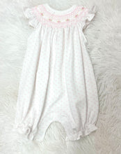Load image into Gallery viewer, Timeless elegance is this charming Pink Tiny Dots Hand Smock Pima Bishop Bubble from Baby Loren. Crafted from premium Pima cotton, this delicate bubble features a crisp white base adorned with dainty pink dots that add a touch of whimsy. The signature bishop smocked neckline showcases meticulous hand-smocking detail.