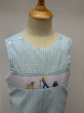 Load image into Gallery viewer, This Boys Gone Fishing Longall showcases a charming blue and white gingham pattern, highlighted by a detailed smocked fisherman & his best friend embroidery on the front. Designed for comfort and style, it pairs perfectly with a classic Peter Pan collar shirt, creating an adorable and polished outfit ideal for playful days and special occasions.