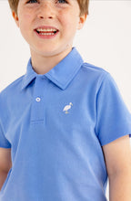Load image into Gallery viewer, Elevate your summer wardrobe with the Prim and Proper Beach Polo in Sunrise Blvd Blue by The Beaufort Bonnet Company. This charming white and blue polo, featuring the iconic TBBC stork, is ideal for sunny adventures and effortlessly complements Sheffield shorts. Available for toddlers to tweens, it's a must-have for every stylish outing!