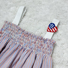 Load image into Gallery viewer, Celebrate your little one's love for the stars and stripes with our Infant Girls 4th of July Patriotic Donna Romper! Made from seersucker fabric in patriotic red, white, and blue, this romper features a smocked bodice and adorable heart US flag embellishment. Perfect for showing off her American pride!