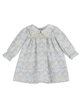 Load image into Gallery viewer, Timeless elegance meets playful charm in this Girls Blue Snowberry Float Dress from Sophie & Lucas. The signature scalloped collar frames a stunning blue and golden yellow floral print, creating a sophisticated silhouette perfect for fall gatherings, holiday celebrations, and cherished photo moments. A classic piece designed to transition seamlessly through the season while maintaining that polished, editorial aesthetic your collection is known for.