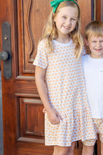 Load image into Gallery viewer, Celebrate the season in style with the Lottie Girl's Harvest Pumpkin Dress by Lila & Hayes. This charming drop waist dress, adorned with a playful pumpkin print, offers a perfect blend of comfort and festive flair. Its short sleeves make it ideal for layering or wearing on warmer days, ensuring your little one stays cozy and cute throughout autumn gatherings and celebrations.