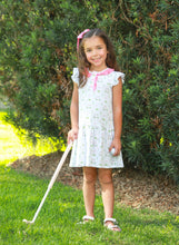 Load image into Gallery viewer, Introducing the Caddy Club Dress from Trotter Street Kids! This charming golf-printed knit dress features delightful ruffle sleeves and a playful drop hem, making it an ideal choice for spring and summer fun. With its breathable design and sweet pink trim, your little girl will feel both comfortable and stylish while enjoying her outdoor adventures. Embrace the joy of childhood with this delightful dress!