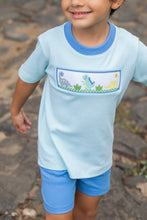 Load image into Gallery viewer, Unleash your little one's adventurous spirit with the Dinosaur Mint Harry’s Play Tee! This vibrant mint-striped knit tee, adorned with playful dinosaur smocking, offers ultimate comfort and breathability, perfect for energetic toddlers. Dress them in style, and watch their imagination roar! Shorts not included.