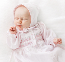 Load image into Gallery viewer, Welcome your little one in style with the Pink Ribbon Smocked Take Me Home Gown With Bonnet by Feltman Brothers. This timeless gown, adorned with classic smocking and charming buttons, creates a perfect backdrop for precious newborn photos. The included bonnet completes this adorable look, ensuring your baby shines on their journey home!