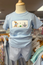 Load image into Gallery viewer, This adorable Boy's Smocked Peter Rabbit Short Set by Anavini will be a charming addition to your little one's wardrobe. The light blue knit tee features a lovely peter rabbit smocking detail, while the light blue gingham shorts add a classic touch. Perfect for any occasion, this set will keep your child looking stylish and comfortable.