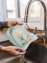 Load image into Gallery viewer, Keep your baby’s clothes clean and dry during feeding time with a nontoxic, food-grade Silicone Bib from JuJuBe × Studio Oh! Made for babies 4 months and older, these bibs feature a deep front pocket to catch messes, and because they are dishwasher-safe, cleanup is fast and easy! Designed to fit comfortably and stay put, each bib features four ouch-free fasteners at the back of the neck strap, so it will stay comfortable as your baby grows.