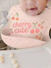 Load image into Gallery viewer, Keep your baby’s clothes clean and dry during feeding time with a nontoxic, food-grade Silicone Bib from JuJuBe × Studio Oh! Made for babies 4 months and older, these bibs feature a deep front pocket to catch messes, and because they are dishwasher-safe, cleanup is fast and easy! Designed to fit comfortably and stay put, each bib features four ouch-free fasteners at the back of the neck strap, so it will stay comfortable as your baby grows.