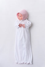 Load image into Gallery viewer, Welcome your newest blessing in The Beaufort Bonnet Company’s Sweetly Smocked Greeting Gown in Worth Avenue White with Palm Beach Pink, featuring smocked details and delicate sleeve accents that make every moment magical. This convertible gown offers the convenience of an elastic bottom for easy diaper changes while keeping baby cozy and comfortable. Ideal for those precious first days at home, hospital photos or gifting to expecting parents.