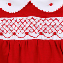 Load image into Gallery viewer, Wrap baby in the warmth and wonder of the season with the Millie Smocked Footie, a timeless piece made for holiday magic by Magnolia Baby. Dressed in a rich, festive red, this one-piece captures the spirit of Christmas with its delicate hand-smocked detailing and embroidered rosebuds, creating a look that feels both classic and heirloom-worthy.