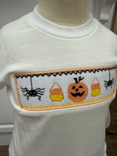 Load image into Gallery viewer, Celebrate fall in style with the Spooky Season Smocked Short Set from Cape Point Clothing. This charming outfit pairs a crisp white tee featuring a playful smocked "Spooky" design with coordinating orange and white gingham shorts. Perfect for your little one’s autumn adventures, this set combines comfort with festive flair, making it ideal for seasonal celebrations and everyday wear. Embrace the spirit of the season with a look that’s both cute and cozy.