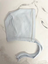 Load image into Gallery viewer, Add a touch of sweetness to your newborn's wardrobe with our Pima Cotton Embroidered Bonnett from Squiggles. Made from high-quality Pima cotton, this bonnet is soft and delicate on baby's skin. The light pink and light blue embroidery add a charming touch, making it a perfect gift addition for any newborn. Complete the look with our matching Embroidered Converter from Squiggles.