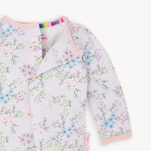 Load image into Gallery viewer, Experience the convenience and beauty of the Emily Floral Footie Pajama from Magnetic Me! The magnetic front closure makes dressing effortless for parents, while the ruffled back adds a touch of sweetness. The lovely lavender and floral design will have your little one looking adorable and feeling cozy all night long.