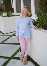 Load image into Gallery viewer, Get your little one ready to cheer in style with the Peggy Peplum Legging Set - Game On Knit by James & Lottie. Featuring a playful football print and matching leggings, this set combines comfort and spirited fun, perfect for showing team pride all season long. Designed for active girls who love to move, it’s an easy way to keep her cozy and stylish during game day or playtime.