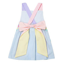 Load image into Gallery viewer, This adorable Rainbow Skye Dress from Zuccini Kids for toddler girls features mini light blue seersucker, vibrant rainbow appliqués on the pockets, and a colorful cross back with bow design. Perfect for any occasion, this dress will have your little one looking cute and stylish while staying comfortable.