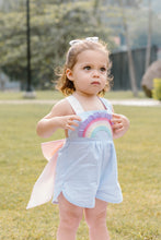 Load image into Gallery viewer, Introduce your little one to a world full of color and fun with our Rainbow Sussie Overall! Part of our adorable Rainbow Skye Dress collection, this overall features charming rainbow appliques on the pockets, a comfortable mini seersucker material, and a colorful crossback and bow design. Perfect for infant and young toddler girls who love to play and look stylish at the same time. Order now and let the adventures begin!