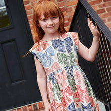 Load image into Gallery viewer, The Girls Adaline Dress in Multi Striped Bows brings a delightful mix of color and charm to your little girl’s wardrobe. Featuring playful striped bows, this dress adds a touch of whimsy while maintaining a stylish silhouette. Its comfortable fit ensures she can move freely, making it ideal for both special occasions and everyday wear. Elevate her look with a dress that combines fun patterns and effortless elegance.