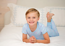 Load image into Gallery viewer, Get your little champion ready for bedtime with the Boys Game On Knit Two Piece Pajama Set from James & Lottie. Featuring a soft blue fabric adorned with playful football prints, this cozy set ensures comfort and style all night long. Perfect for active boys who love sports, these pajamas make winding down feel like scoring a touchdown.