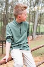 Load image into Gallery viewer, The Prodoh Pro Performance 1/4 Zip Pullover combines comfort and versatility for active boys. Crafted in a striking Camping Hedge Green Stripe, this pullover features a quarter-zip design for easy layering and temperature control. The performance fabric is designed to move with your child through outdoor adventures, playtime, and everyday wear.
Available in sizes 2T through 14, this sweatshirt transitions seamlessly from casual outings to more structured activities. The durable construction and timeless co