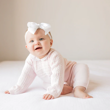 Load image into Gallery viewer, Girls Cable Knit Longall Pink- A precious outfit for your precious baby. It features raglan sleeves in a cable knit design, and ribbed cuffs along the sleeves and legs. Check out the sweet little peter pan collar, with darling hand made bullions lining the edges. Opens with snaps along the crotch for convenient changing. This knit longall is sure to become a family favorite!