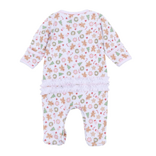 Load image into Gallery viewer, Dress your baby girl in cozy comfort and festive charm with this Frosted Wonderland footie. Made from 100% soft, breathable Pima Cotton, it gently caresses delicate skin while keeping your little one comfortable all day. The delightful all-over print of gingerbread girls, stars, snowflakes, and ruffle back adds a sweet holiday touch, making it the perfect choice for seasonal celebrations and cozy winter moments. Sibling matches available!