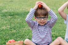 Load image into Gallery viewer, From dock to dinner, this Boy's Long Sleeve Pro Performance Polo in Blue and Pink Stripe  is your go-to for smart, southern style. Classic stripes and embroidered fish logo add a playful, signature touch. Whether he's headed to school, church, the family fish fry, course, or court, this performance polo will move with him in style and comfort!