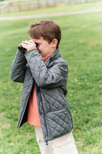 Load image into Gallery viewer, For the kid who loves wide-open spaces and muddy adventures, the Kids Quilted Barn Jacket in Fly Fishing Green is a countryside classic reimagined for modern explorers. Designed with a tailored fit, diamond-quilted finish, and rugged detailing, this jacket brings cozy warmth and timeless style from pumpkin patch to pasture.
