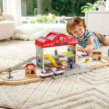 Load image into Gallery viewer, Bring the thrill of train travel home with the Portable Train Station Set by Hape. Featuring 41 pieces, including a 3-car train, tracks, a conductor, and fun accessories, this set sparks endless creative play. Its clever design transforms the station into a portable carrying case, making cleanup simple and travel hassle-free. Ideal for children ages 3 and up, it’s the perfect way to keep playtime organized and exciting wherever you go.