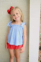 Load image into Gallery viewer, Elevate your little girl's wardrobe with this charming Blue Gingham Knit Tie Top from James & Lottie. The timeless blue and white gingham pattern creates an irresistible look, while the playful tie straps add a touch of whimsy. This versatile piece transitions effortlessly from playground to parties, and creates a perfect patriotic ensemble when paired with the red Kinley Ruffle Shorts. A must-have addition that combines comfort and classic style for your fashion-forward little one.