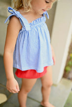 Load image into Gallery viewer, Elevate your little girl's wardrobe with this charming Blue Gingham Knit Tie Top from James & Lottie. The timeless blue and white gingham pattern creates an irresistible look, while the playful tie straps add a touch of whimsy. This versatile piece transitions effortlessly from playground to parties, and creates a perfect patriotic ensemble when paired with the red Kinley Ruffle Shorts. A must-have addition that combines comfort and classic style for your fashion-forward little one.