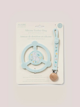 Load image into Gallery viewer, Help soothe your baby’s sore gums with the Silicone Teether Ring with Detachable Clip from JuJuBe x Studio Oh! This teether features an easy-to-grip design and three different massaging textures so Baby can choose what feels best. Place it in the freezer before use for additional cooling relief. This nontoxic, food-grade silicone teether is dishwasher-safe, and most importantly, it is BPA-free, PVC-free, phthalate-free, and lead-free, making it safe to go in Baby’s mouth. A snug-closing clip and silicone lo