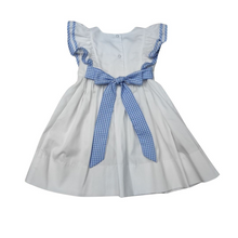 Load image into Gallery viewer, Tie back fun and fashion with Delaney's White Pique Apron Ruffle Dress for toddler girls. Featuring adorable ruffles and charming blue check details, this dress is perfect for adding a personalized touch with a monogram. Make your little one stand out in style and grab the matching girl's infant bubble for a sibling match!