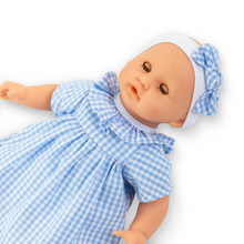 Load image into Gallery viewer, Meet Bébé Calin Milly, the perfectly sized companion for young doll enthusiasts. Milly mimics real baby movements—she sits independently, sleeps when laid on her back, and even enjoys her thumb or pacifier. Her delicate features include soft-touch vinyl skin, peaceful blue eyes, and that signature vanilla scent Corolle is known for. Dressed in an adorable blue gingham outfit with matching headband.