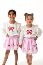 Load image into Gallery viewer, Celebrate the season in style with the Candy Canes Ruffle Shoulder French Terry Sweatshirt from Angel Dear. This cozy sweatshirt features charming ruffle details on the shoulders, adding a festive touch to your little one's wardrobe. Made from soft French terry fabric, it ensures comfort during holiday playtime. Pair it with the matching Candy Canes Tutu Skirt for an adorable and playful holiday outfit that will make your child the star of any celebration. 