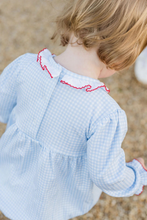 Load image into Gallery viewer, Infant Girls Sara Smocked Long Sleeve Bubble from James & Lottie brings festive charm to your little one's wardrobe. This delightful piece features a soft blue and white gingham knit with hand-smocked Christmas wreaths adorning the front, finished with an elegant ruffle-trimmed collar. Perfect for holiday celebrations and special occasions, the bubble silhouette offers comfortable movement for active toddlers. Coordinate with the matching toddler dress to create adorable sibling sets that capture those