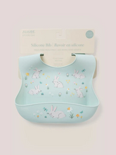 Load image into Gallery viewer, Keep your baby’s clothes clean and dry during feeding time with a nontoxic, food-grade Silicone Bib from JuJuBe × Studio Oh! Made for babies 4 months and older, these bibs feature a deep front pocket to catch messes, and because they are dishwasher-safe, cleanup is fast and easy! Designed to fit comfortably and stay put, each bib features four ouch-free fasteners at the back of the neck strap, so it will stay comfortable as your baby grows. The Silicone Bib is BPA-free, PVC-free, phthalate-free, and lead-fr