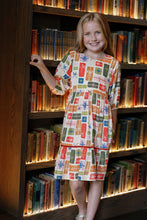 Load image into Gallery viewer, Briton Court’s Hattie Present Dress delights with its soft cream knit and charming present print. Vibrant orange velvet ribbons add playful warmth, making it perfect for joyful celebrations and everyday magic—from toddlers to tween girls.
