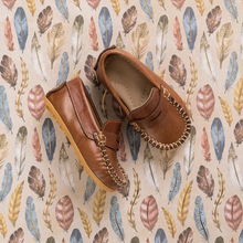 Load image into Gallery viewer, The Alex Driver combines sporty comfort and polished chic for your little boy. Crafted from premium leather and lined with natural sheepskin, these shoes offer softness, protection, and moisture absorption. The lightweight, flexible rubber outsole ensures durability. Cushioned insoles made from recycled leather and Bontex add support. Featuring a diamond-shaped cutout and hand-sewn stitching, these shoes are perfect for any occasion. Made in Peru with fair trade practices, they ensure ethical craftsmanship.
