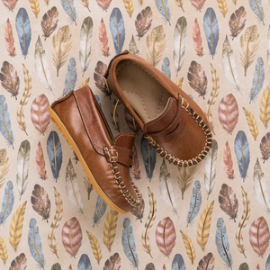 The Alex Driver combines sporty comfort and polished chic for your little boy. Crafted from premium leather and lined with natural sheepskin, these shoes offer softness, protection, and moisture absorption. The lightweight, flexible rubber outsole ensures durability. Cushioned insoles made from recycled leather and Bontex add support. Featuring a diamond-shaped cutout and hand-sewn stitching, these shoes are perfect for any occasion. Made in Peru with fair trade practices, they ensure ethical craftsmanship.