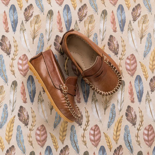 The Alex Driver combines sporty comfort and polished chic for your little boy. Crafted from premium leather and lined with natural sheepskin, these shoes offer softness, protection, and moisture absorption. The lightweight, flexible rubber outsole ensures durability. Cushioned insoles made from recycled leather and Bontex add support. Featuring a diamond-shaped cutout and hand-sewn stitching, these shoes are perfect for any occasion. Made in Peru with fair trade practices, they ensure ethical craftsmanship.