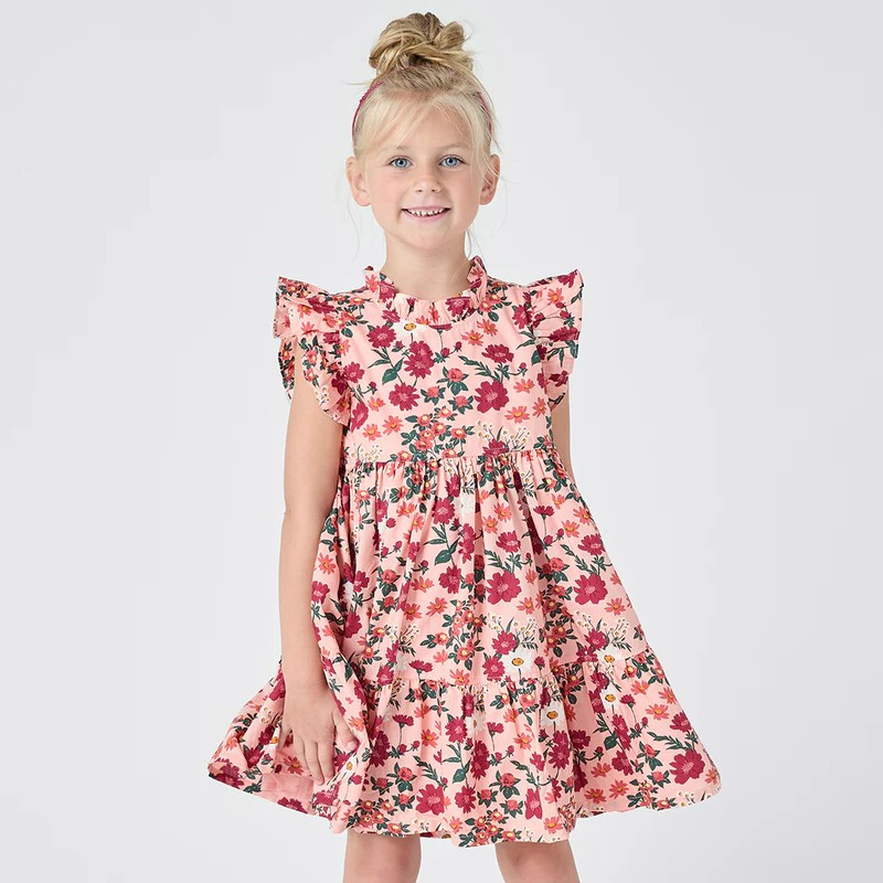 Fresh As A Daisy! A patch of wild daisies in shades of red, orange and white springs from a blush colored ground in our Pink Daisy Floral shown here on our Girls Jennifer Dress. This short sleeve flock favorite silhouette delights with its feminine ruffled neck and sleeves and fully gathered, two tiered skirt that spins like a dream. Invisible zipper. A silver thread woven throughout adds a touch of shimmer and shine. Match back to Little Sis in our Baby Girls Jennifer Bubble. 